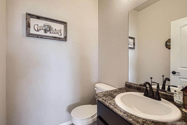 half bath with vanity and toilet