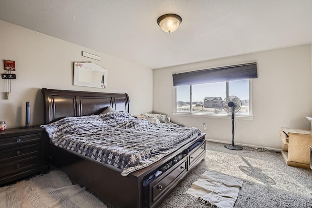 bedroom featuring carpet floors and baseboards