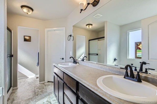 full bath featuring baseboards, a shower stall, visible vents, and a sink