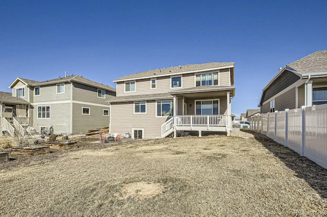 rear view of property with fence