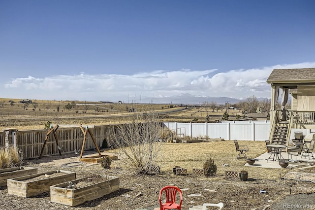 view of yard featuring a fenced backyard and a vegetable garden