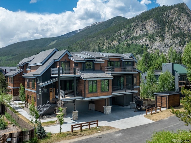 310 Creekside Aly Unit 4, Frisco, CO 80443 - back of house featuring a balcony, a mountain view, and driveway