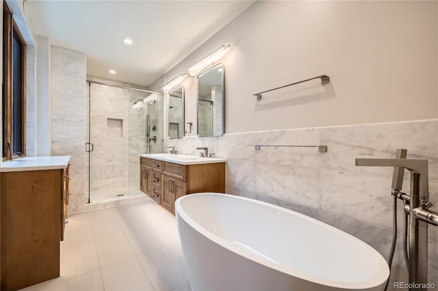 310 Creekside Aly Unit 4, Frisco, CO 80443 - bathroom featuring vanity, a freestanding tub, a shower stall, tile walls, and recessed lighting