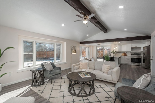 living room with ceiling fan, lofted ceiling with beams, sink, and light hardwood / wood-style flooring