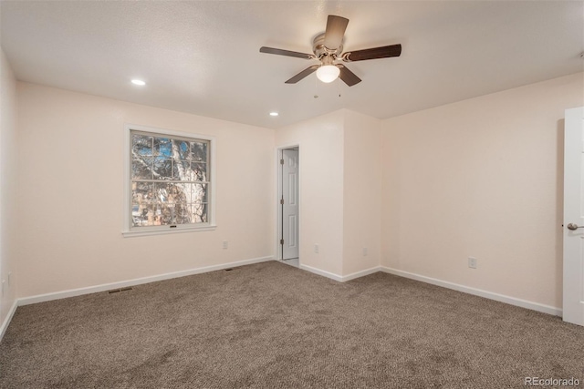 carpeted spare room with ceiling fan