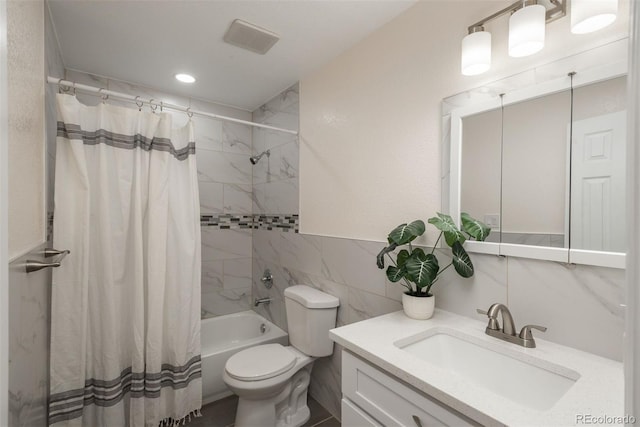 full bathroom with tile walls, toilet, vanity, and shower / bath combination with curtain