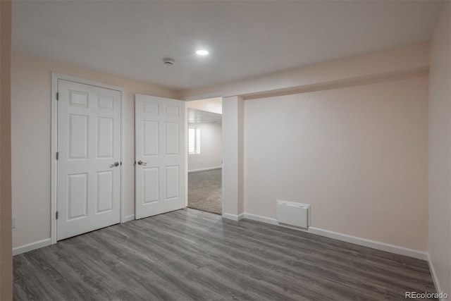 unfurnished bedroom featuring a closet and dark hardwood / wood-style floors