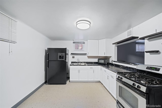 3131 S Washington St, Englewood, CO 80113 - kitchen with black appliances, dark countertops, white cabinets, and light floors