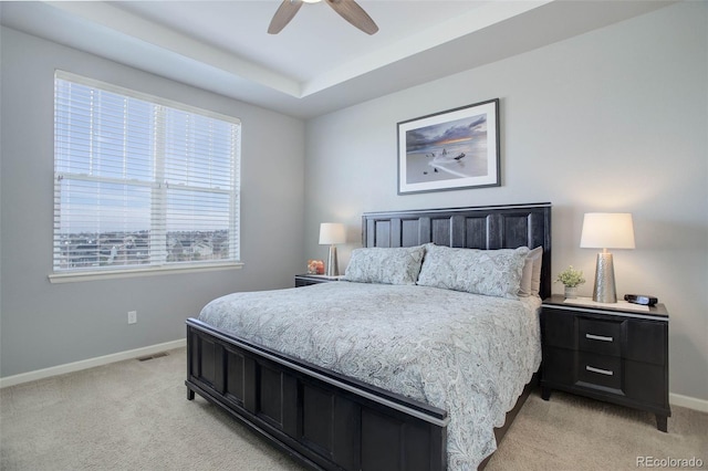 bedroom with ceiling fan, baseboards, visible vents, and light carpet