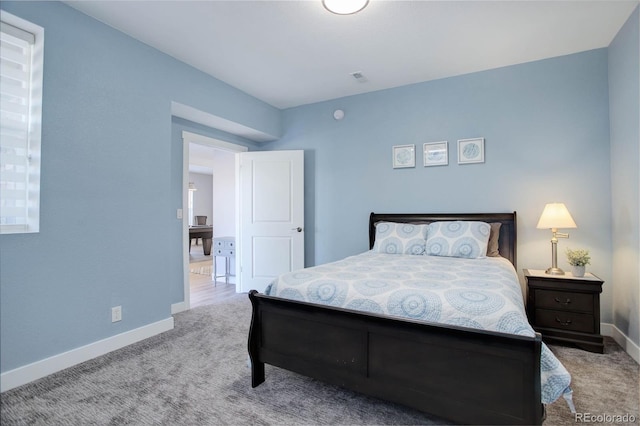 carpeted bedroom featuring visible vents and baseboards