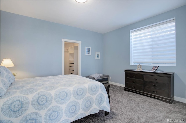 bedroom with baseboards and carpet