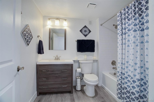 full bath with visible vents, toilet, vanity, and wood finished floors