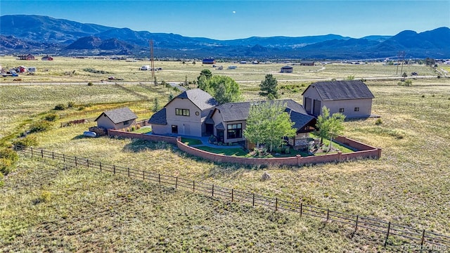 birds eye view of property featuring a mountain view and a rural view