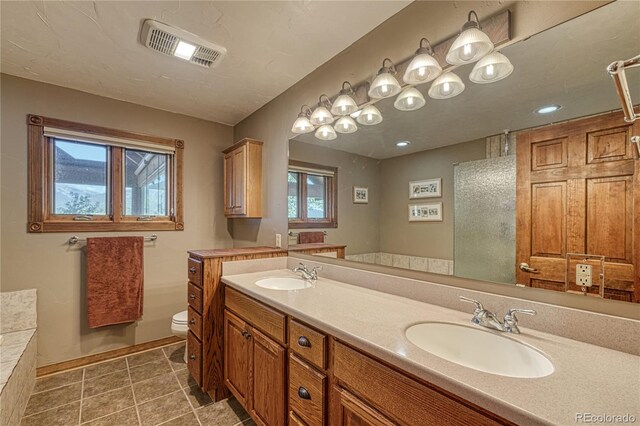 bathroom with a tub to relax in, vanity, and toilet