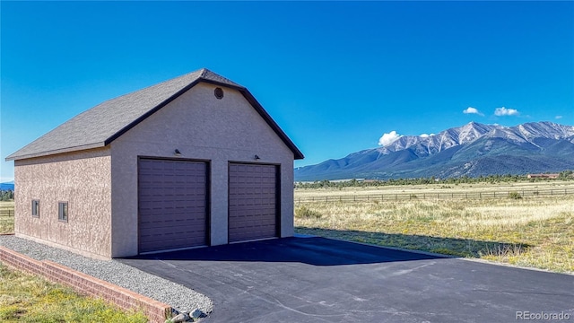 detached garage featuring a mountain view