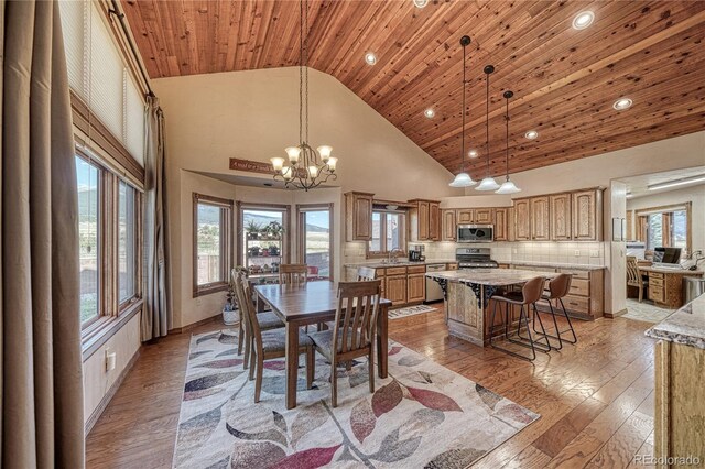 dining space with light wood-type flooring, high vaulted ceiling, recessed lighting, wooden ceiling, and a chandelier