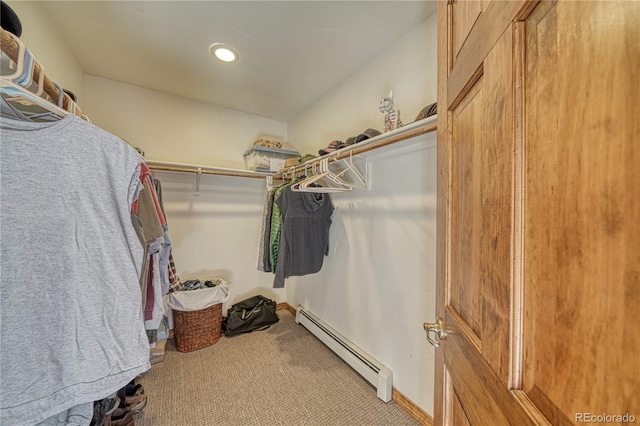 spacious closet featuring baseboard heating and carpet