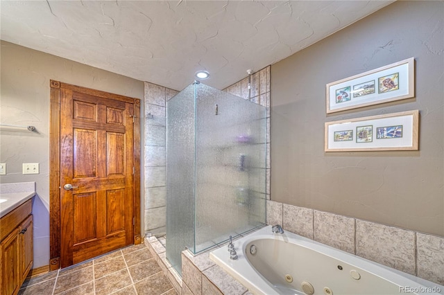 bathroom with tile patterned floors, vanity, and separate shower and tub