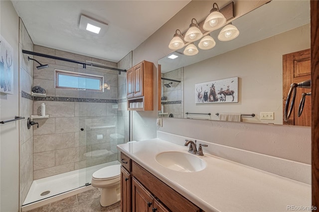 bathroom featuring vanity, an enclosed shower, and toilet