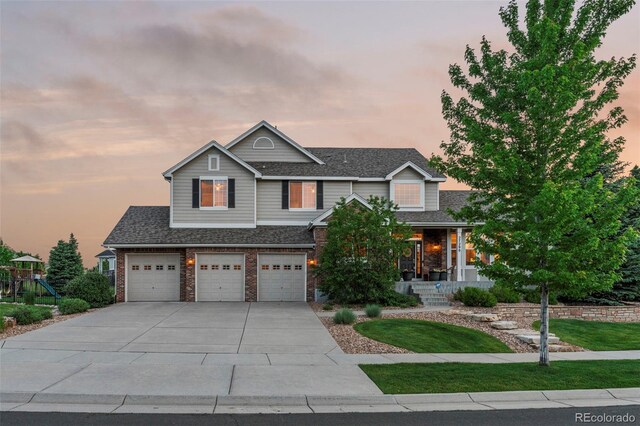 27290 E Nova Cir, Aurora, CO 80016 - view of front of house featuring a porch, brick siding, driveway, a garage, and a front lawn