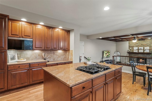 27290 E Nova Cir, Aurora, CO 80016 - kitchen featuring stainless steel microwave, black gas cooktop, light wood finished floors, a ceiling fan, and recessed lighting