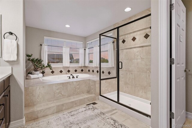 27290 E Nova Cir, Aurora, CO 80016 - bathroom featuring a bath, vanity, a stall shower, and recessed lighting