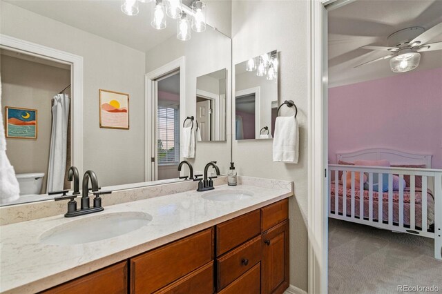 27290 E Nova Cir, Aurora, CO 80016 - full bath featuring double vanity, a ceiling fan, and a chandelier