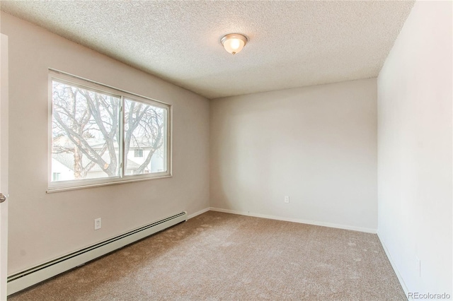 carpeted spare room featuring a textured ceiling and a baseboard heating unit