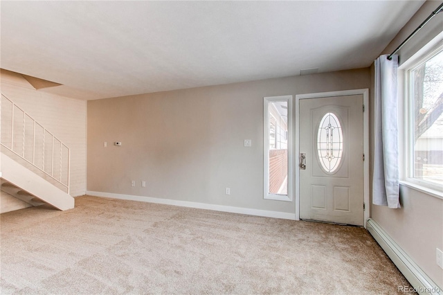 entrance foyer with a baseboard radiator and light carpet