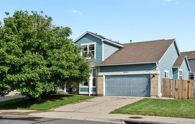 view of front of property with brick siding, driveway, a garage, and fence