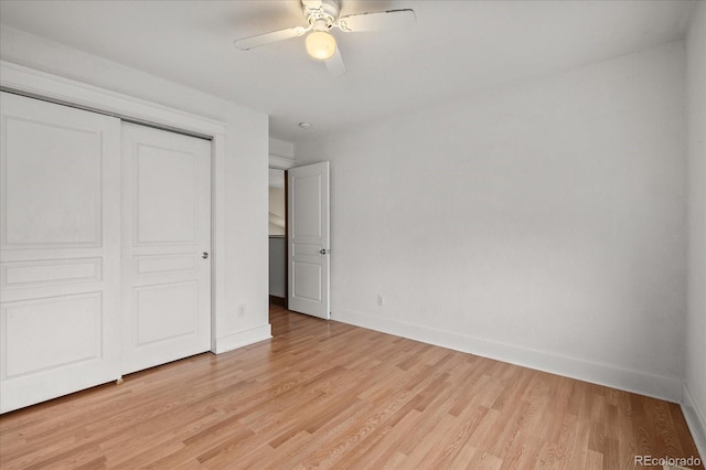 unfurnished bedroom with a ceiling fan, baseboards, a closet, and light wood finished floors