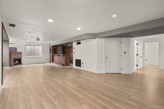 unfurnished living room featuring light wood finished floors, visible vents, ceiling fan, recessed lighting, and a fireplace