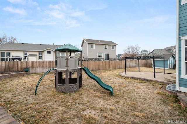 view of jungle gym featuring a patio area, a residential view, and a fenced backyard