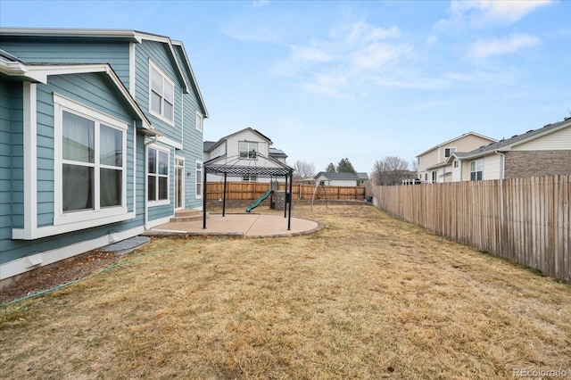 view of yard featuring a gazebo, a patio, and a fenced backyard