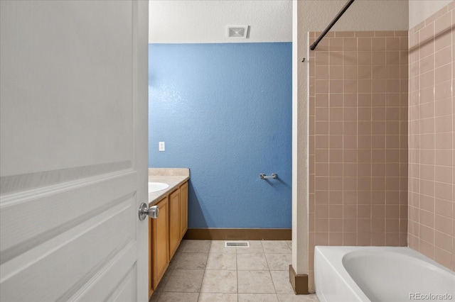 full bathroom featuring visible vents, baseboards, shower / bath combination, tile patterned floors, and vanity