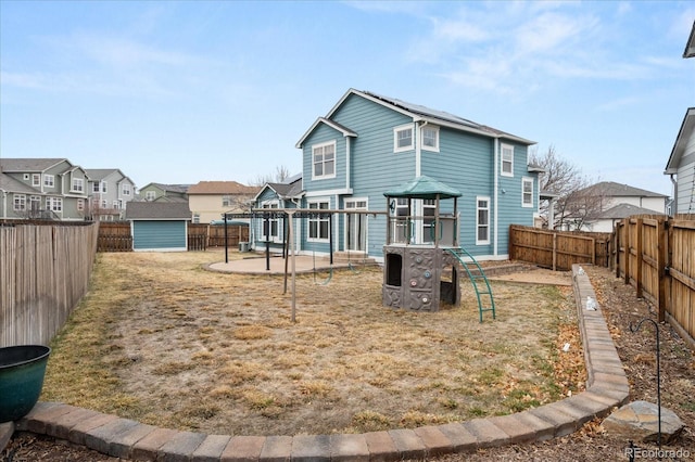 back of house with a patio, a fenced backyard, a residential view, a storage shed, and an outdoor structure