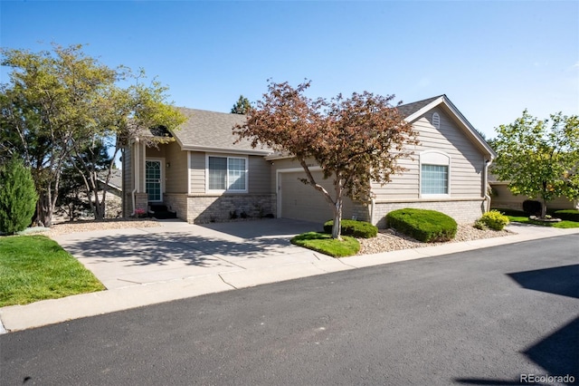 9567 Brentwood Way Unit A, Broomfield, CO 80021 - view of front of home with brick siding, a garage, and driveway