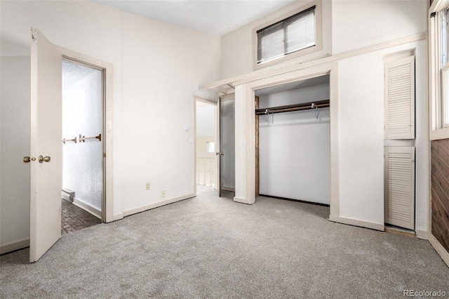 unfurnished bedroom featuring carpet floors, a closet, and baseboards