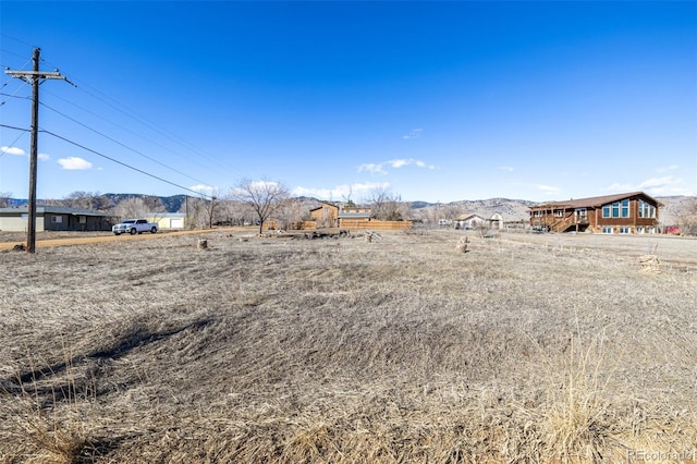 view of yard with a mountain view and a rural view