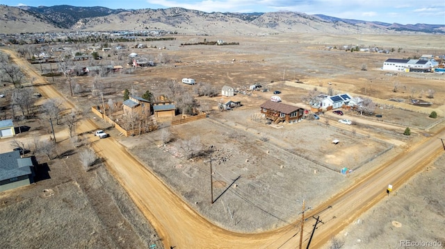 birds eye view of property with a mountain view and a rural view