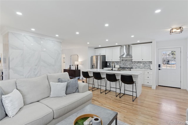 living room featuring sink and light hardwood / wood-style flooring