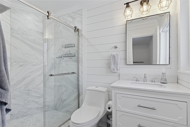 bathroom with vanity, toilet, and a shower with door