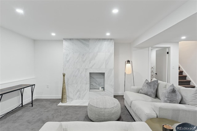 living room featuring carpet and a high end fireplace