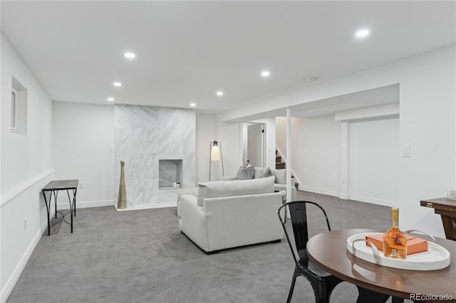 carpeted living room featuring a high end fireplace