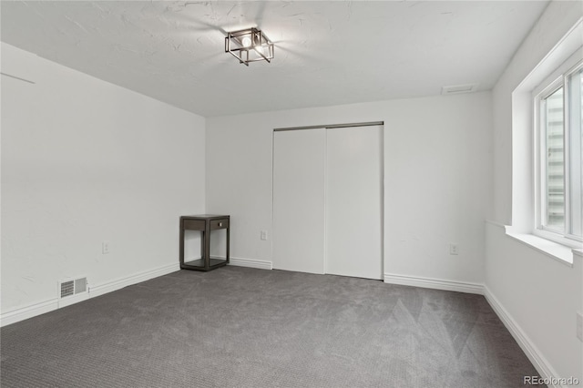 unfurnished bedroom with carpet floors and a closet