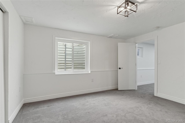 empty room with carpet and a textured ceiling