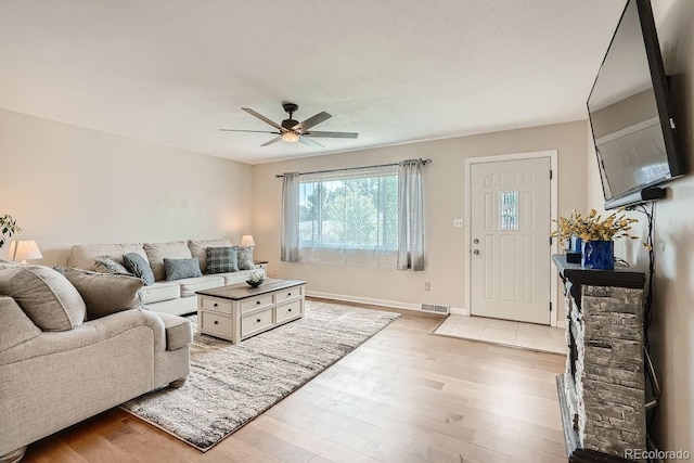 living room with ceiling fan and light wood-type flooring