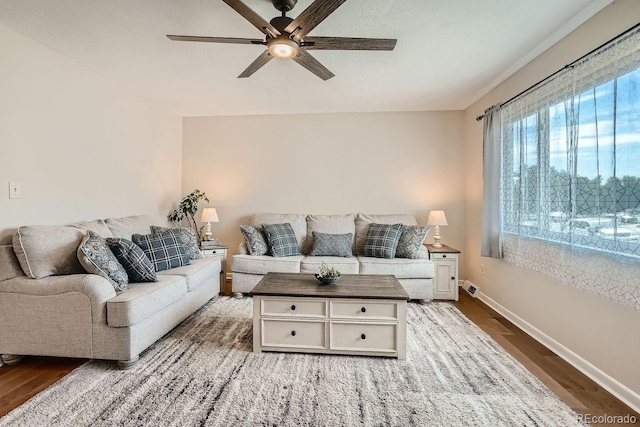 living room featuring hardwood / wood-style floors and ceiling fan