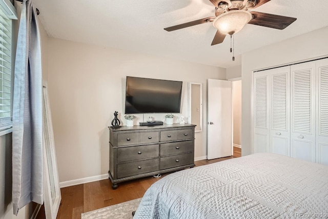 bedroom with hardwood / wood-style floors, ceiling fan, and a closet