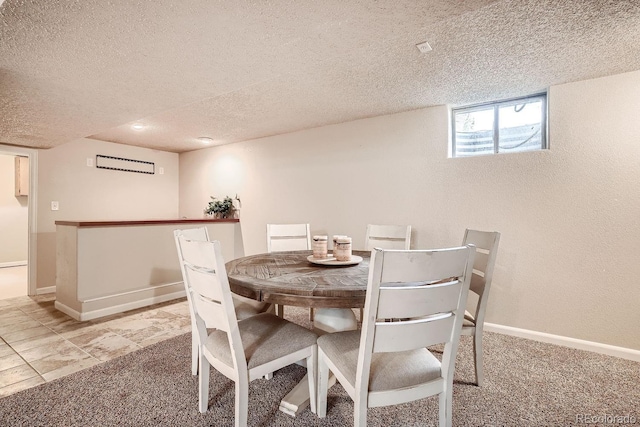 dining room with carpet floors and a textured ceiling